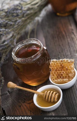 Sweet honey in the comb. Jar of honey with honeycomb