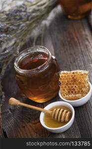 Sweet honey in the comb. Jar of honey with honeycomb