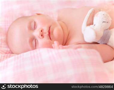 Sweet kid sleeps, relaxing in the bed, adorable healthy child dreaming, happy life concept