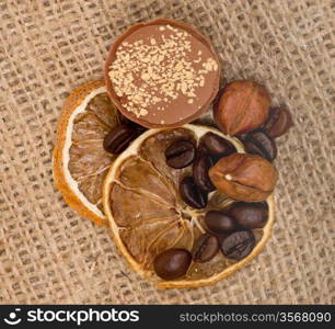 Sweet, lemon, nuts and coffee beans on burlap