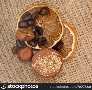 Sweet, lemon, nuts and coffee beans on burlap