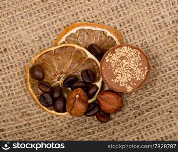 Sweet, lemon, nuts and coffee beans on burlap