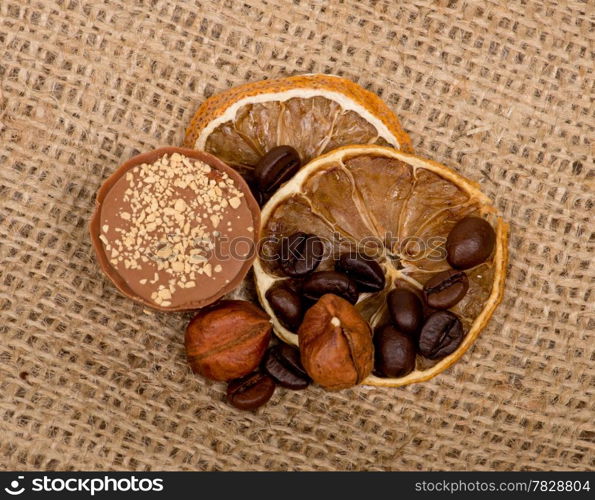 Sweet, lemon, nuts and coffee beans on burlap