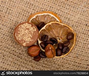 Sweet, lemon, nuts and coffee beans on burlap