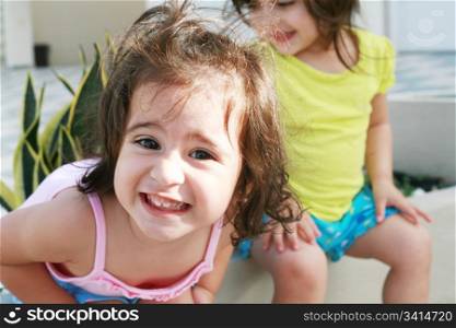 Sweet little girls in front of her little house for playtime (focus on the front girl)