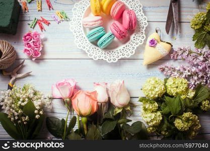Sweet macarons and flowers - preparation of present. Sweet present