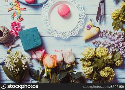 Sweet macarons and flowers - preparation of present. Sweet present top view