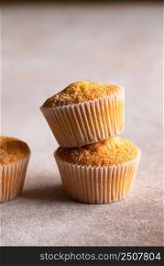 Sweet muffins with powdered sugar. Homemade bakery. Muffins in white capsules.