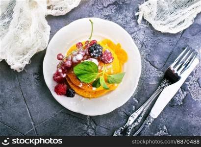 sweet pancakes with berries on the plate