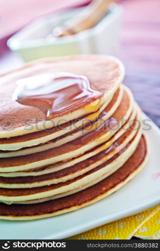 sweet pancakes with honey on the plate