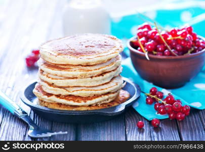 sweet pancakes with red currant on the plate