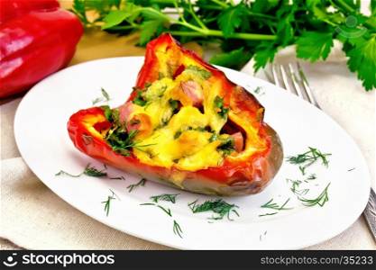 Sweet pepper stuffed with sausage, egg and cheese with dill in a plate on a napkin, parsley on the background of the stone table