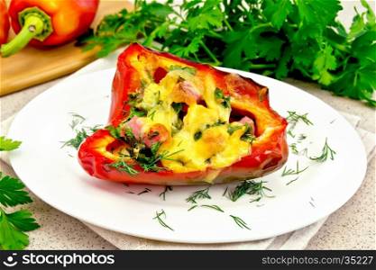 Sweet pepper stuffed with sausage, egg and cheese with dill in white plate on a napkin, parsley on the background of the stone table