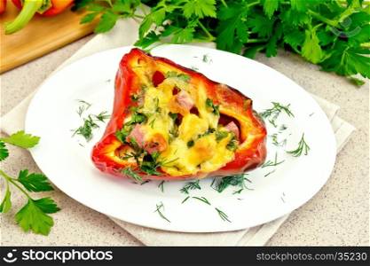 Sweet pepper stuffed with sausage, egg and cheese with dill in white plate on a napkin, parsley on a background of a granite table