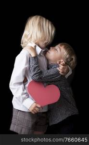 Sweet photo of a young boy kissing his blonde sister