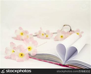 Sweet pink diary with heart shape paper and artificial flower