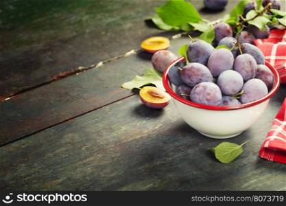 Sweet plums on wooden background.Bio healthy fruits. Selective focus. Copy space background