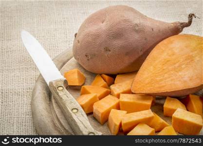 sweet potato cut and diced on a cutting board