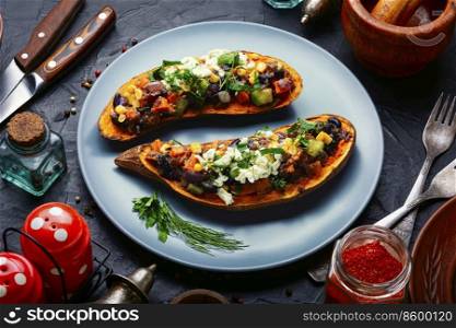 Sweet potato halves baked with vegetables and cottage cheese. Vegetarian food. Sweet potato, batata baked with vegetables.