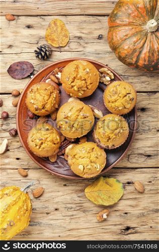 Sweet pumpkin muffins with nuts.Autumn food.Homemade autumn pumpkin muffins with nuts. Homemade pumpkin muffins