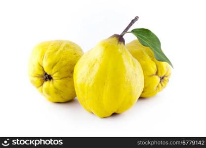 sweet quinces. sweet quinces with leaves and slice on white background