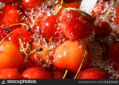 sweet red cherry under wet macro close up