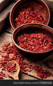 Sweet red sliced pepper as seasoning.Indian spices.Hot chili.. Heap of red pepper flakes