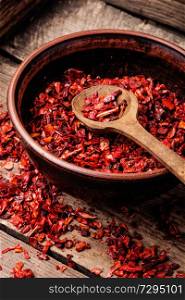Sweet red sliced pepper as seasoning.Indian spices.Paprika powder. Heap of red pepper flakes