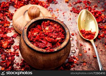 Sweet red sliced pepper as seasoning. Spice for meat dishes. Heap of red pepper flakes
