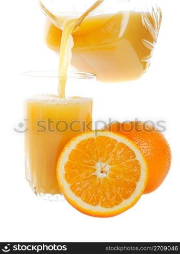 Sweet, refreshing orange juice being poured into a glass. Studio isolated on white background.