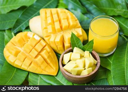 Sweet ripe mangos / Mango juice glass with mango slice on mango leaves from tree tropical summer fruit concept
