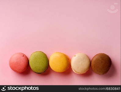 Sweet round macarons on a pink background