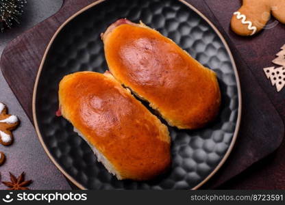 Sweet tasty fresh festive baking on a dark concrete background. Preparing for Christmas Eve. Sweet tasty fresh festive baking on a dark concrete background