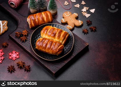 Sweet tasty fresh festive baking on a dark concrete background. Preparing for Christmas Eve. Sweet tasty fresh festive baking on a dark concrete background