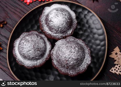 Sweet tasty fresh festive baking on a dark concrete background. Preparing for Christmas Eve. Sweet tasty fresh festive baking on a dark concrete background