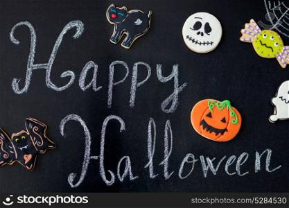 "Sweet terror is coming. Blackboard with the word "Halloween" and cookies"