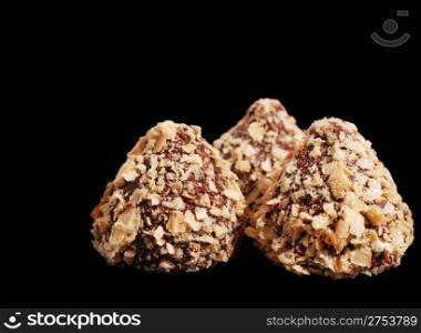 Sweets - a truffle. Isolated on a black background