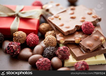 sweets concept - close up of handmade chocolate candies and red gift box. close up of handmade chocolate candies