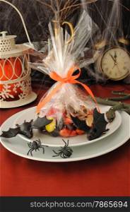 Sweets in the package on the festive table in honor of Halloween