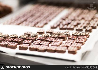 sweets production and industry concept - chocolate candies at confectionery shop. chocolate candies at confectionery shop