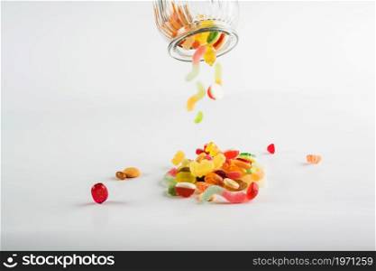 sweets spilling from jar. High resolution photo. sweets spilling from jar. High quality photo