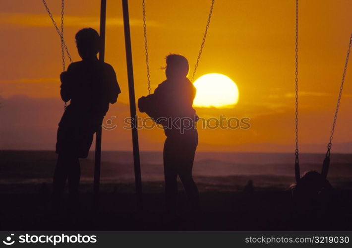 Swiming on a Swingset at Sunset