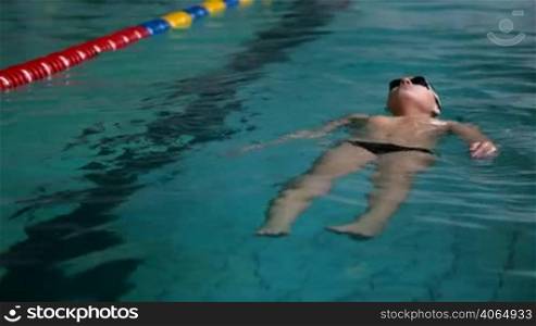 swimmer boy floating in a swimming pool