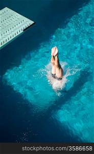 Swimmer diving into swimming pool