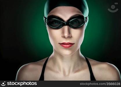 swimmer in glasses on dark green background