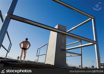 Swimmer standing on diving board