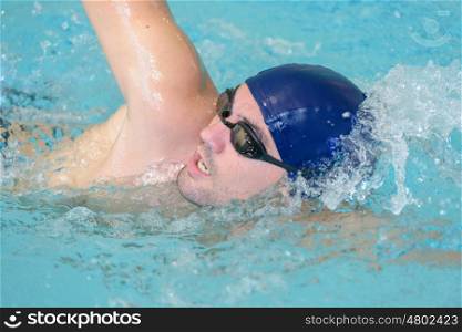 swimmer training in indoor swimming pool
