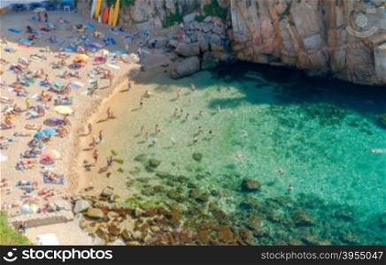 Swimmers in the clear water at the beach in Tossa de Mar.. Tossa de Mar. City Beach.