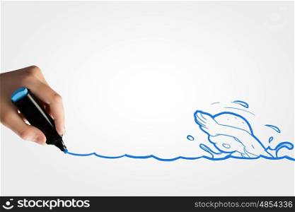 Swimming activity. Close up of human hand drawing caricature of swimming man