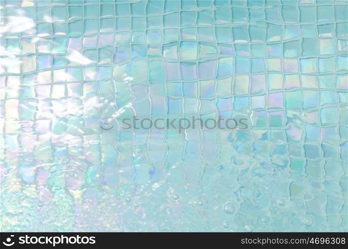 swimming and background concept - turquoise water in tiled pool. turquoise water in tiled swimming pool
